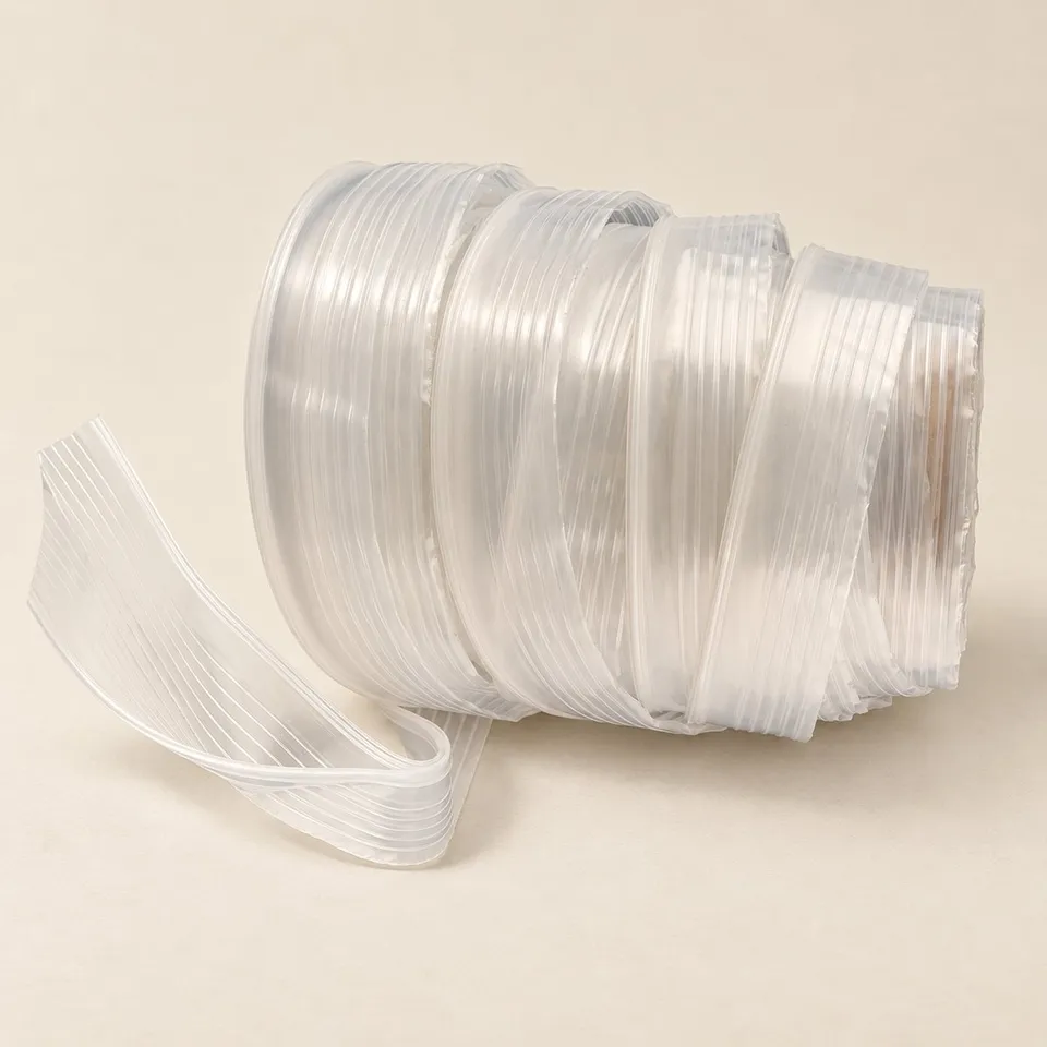 A 35 mm bottom joint zipper profile wound on a core, its joined web visible where a length lifts away.